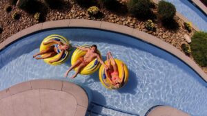 family together in lazy river pool at hotel